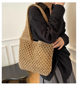 Detailed side view of a woven mesh shoulder bag on a model for beach vacation