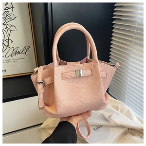 Detail of pink lychee pattern bucket bag with silver metal buckle and adjustable strap