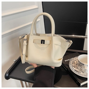 Detail of cream lychee texture leather bucket bag with silver buckle and stitching