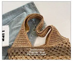 Detail shot of the comfortable wide shoulder strap and woven texture of the beach bag