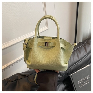 Detailed macro view of the light green lychee grain leather and metal buckle detail