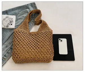 Detail view of large straw tote bag capacity with hollow woven texture and wide shoulder strap