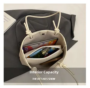 Internal capacity of beige tote bag showing tablet, cosmetics and large storage space