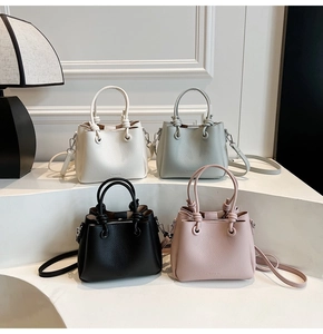Detailed view of bucket bags in beige, blue, black, and pink with lychee texture