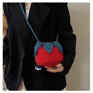 Close-up of strawberry crochet knit bag showing texture and floral detail