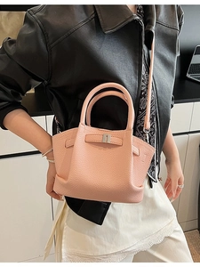 Pink lychee grain leather trapezoid bucket bag with silver hardware and shoulder strap