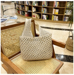 Close-up of beige crochet tote bag with hollow diamond mesh pattern and inner lining