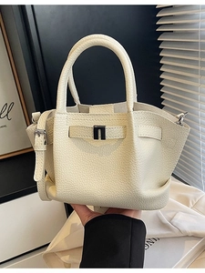 Chic beige leather bucket bag with silver metal buckle and adjustable strap