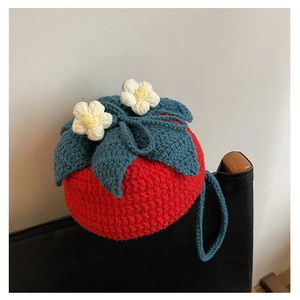 Close-up of handmade knit shoulder bag featuring tomato shape and 3D floral details