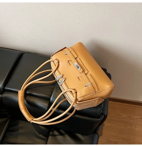 Caramel leather shoulder bag with silver turn-lock and horizontal belt detail