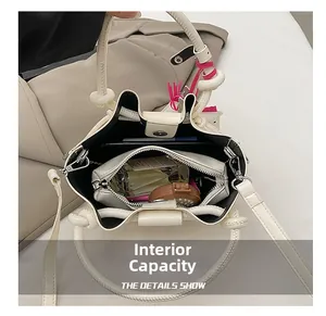 Top view of cream bucket bag showing inner zipper pouch and storage space for essentials