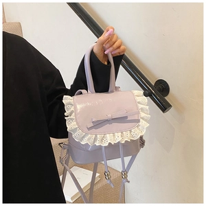 Detail of lavender mini bag featuring white lace edges and a sweet decorative bow