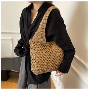Macro shot of large mesh hollow weave texture and inner lining on straw shoulder bag