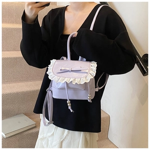 Detailed view of lavender ballet-style mini backpack with lace trim and bow knot
