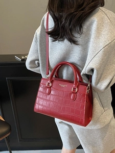 Elegant red crocodile textured tote bag with top handle and gold-tone hardware for weddings