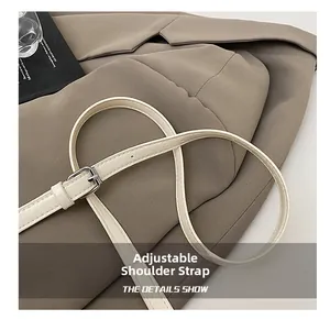 Detail of cream stone-texture faux leather adjustable strap with silver buckle hardware