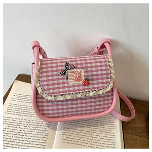 Detail of pink plaid canvas bag featuring lace trim and cute strawberry bow decoration