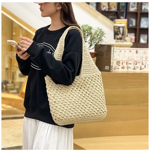 Detailed close-up of handmade beige crochet mesh texture on this summer beach shoulder bag