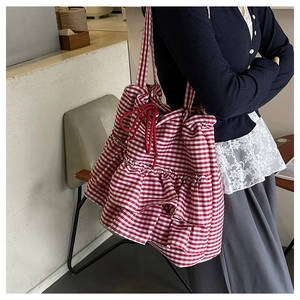 Detail of red and white gingham tote bag with layered ruffles and drawstring closure