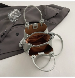 Top view of bucket bag with lychee texture, brown lining and zip compartment detail