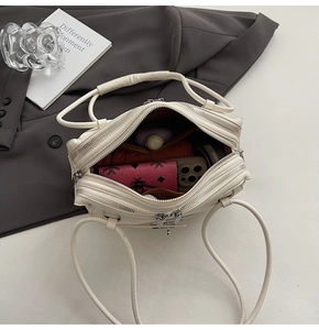 Top view of cream white shoulder bag showing organized interior compartments and pockets