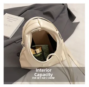 Internal view of the cream leather bucket bag showing storage capacity and interior space