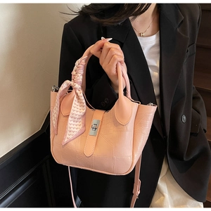 Close-up of pink stone pattern bucket bag with silver lock and silk scarf detail