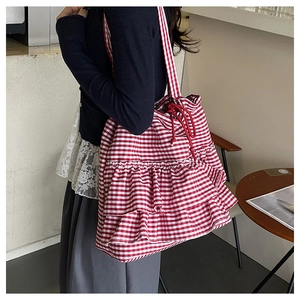 Detail of red gingham tote bag with layered ruffles and red rope drawstring closure