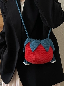 Handmade red strawberry crochet shoulder bag for women with green leaf pattern and knit strap