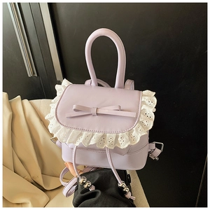 Close-up of lavender PU leather backpack with white lace trim and bow knot detail