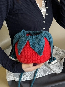 Handmade knitted strawberry drawstring shoulder bag in red and green crochet design