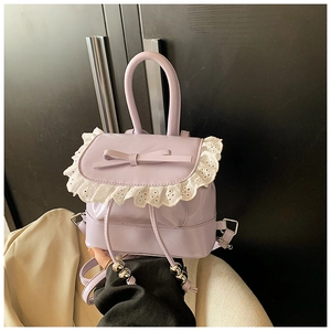 Close-up of light purple mini backpack featuring lace trim and a sweet ribbon bow
