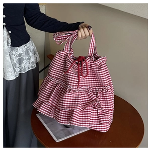 Close-up of red and white gingham canvas tote bag with triple-layered ruffle details