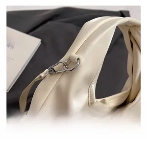 Detail of silver metal hook and 'NO FILTER' strap on off-white bucket bag