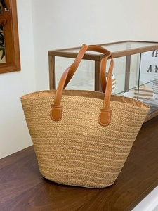 Large straw tote bag with brown leather handles for summer beach vacations and daily use