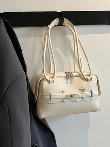 Minimalist cream white underarm bag with silver twist lock and slim shoulder straps