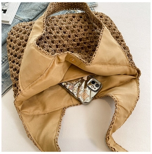 Detail view of woven beach bag interior with magnetic clasp and fabric lining