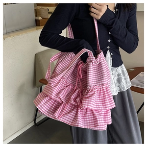 Detail of pink plaid tote bag with tiered ruffles and drawstring closure