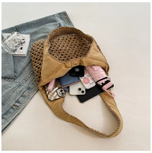 Close-up of woven straw beach bag interior with magnetic closure and large capacity