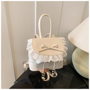 Detailed view of cream ballet-style backpack featuring a silk bow and lace trim decoration