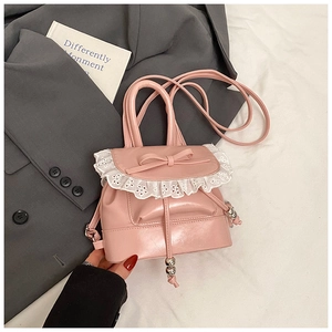 Detailed view of pink mini backpack with white lace trim and elegant bow detail