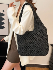 Minimalist black crochet woven straw tote bag for beach vacations and casual summer fashion