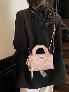 Pink quilted leather crossbody bag with silver chain and bow pearl charm detail