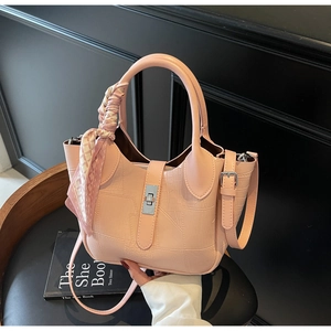 Pink croc-embossed bucket bag detail with silver lock and silk scarf handle accent