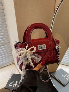 Red quilted patent leather crossbody bag with silver lock and pearl heart charm decor
