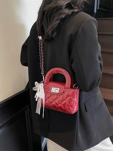 Red quilted patent leather mini handbag with pearl lace bow and silver twist lock detail