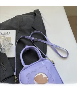 Detail view of purple patent leather bag with bear window on a grey blazer background