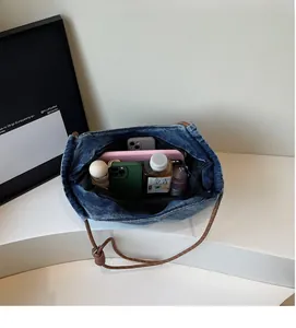 Top view showing the spacious inner compartment of the blue denim tote bag for daily essentials
