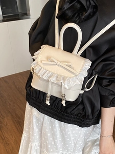 Mini white ballet-style backpack with bow tie and lace trim detail for a sweet fashion look