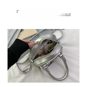 Silver metallic crossbody shell bag showing spacious interior with daily essentials